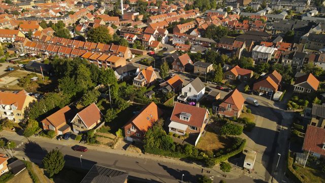 Drone shot capturing a picturesque neighborhood in Horsens, Denmark, with red-roofed houses.